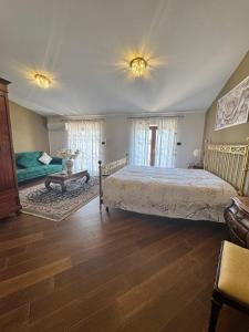 a bedroom with a large bed and a table at B&B Anna in Marigliano +17 photos