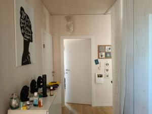 a room with a white door and a refrigerator at Guest room with private shower and toilet near Salzburg City in Kuchl