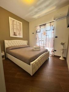 a bedroom with a large bed and a window at B&B Anna in Marigliano +17 photos