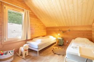 a bedroom with two beds in a wooden room at Chalet les Buffettes - 4P8 in Saint-Jean-dʼArves