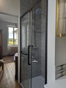 a shower with a glass door in a bathroom at Chateau De Chaunac in Naves