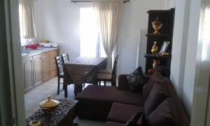 a living room with a couch and a table at Kazonis Studios in Kalymnos