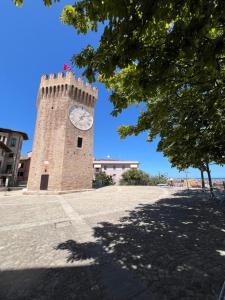 a brick clock tower with a clock on it at CaseNuoveSette in San Benedetto del Tronto
