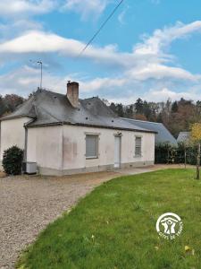 a white house with a gray roof and a yard at LA MANCELLIERE in LʼHuisserie