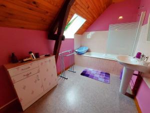 a bathroom with pink walls and a sink and a tub at Lusachères in La Pellerine +24 photos