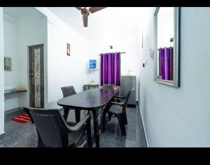 a dining room with a table and chairs at Rainbow Residency Auroville in Auroville