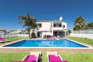 a villa with a swimming pool and a house at Villa Soni by Villa Plus in Olhos de Água