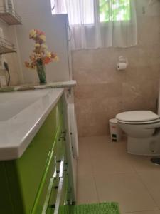 a bathroom with a white sink and a toilet at Apartamento Ura in Morro del Jable