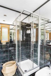 a glass shower in a bathroom with a sink at Boutique Caravaggio in Rome