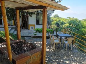 a patio with a table and chairs and a grill at Apartamento Campestre Medellin in Medellín