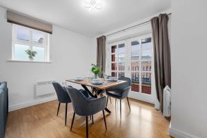 a dining room with a table and chairs at Modern Apartment, Free Parking by City SuperHost in Altrincham