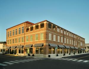a brick building on the corner of a street at Hotel 1928 in Waco
