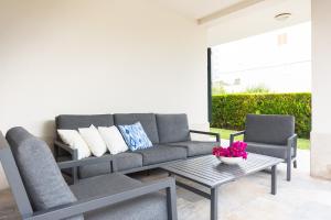 a living room with a couch and a table at Chalet Muro en Mallorca in Playa de Muro