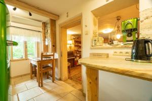 a kitchen with a counter and a table in a room at Chatka Koniaków 7 in Koniaków