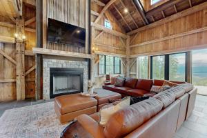 a living room with a couch and a fireplace at The Barn House in Lakeside
