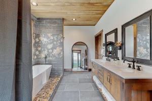 a bathroom with two sinks and a bath tub and a tubermott at The Barn House in Lakeside +16 photos