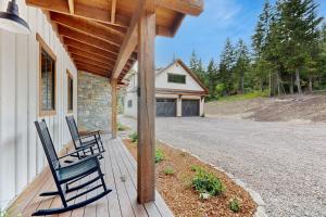 two chairs sitting on a porch of a house at The Barn House in Lakeside