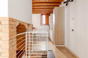 a spiral staircase in a kitchen with a brick wall at Appartamento La Sosta in Piacenza