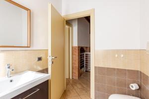 a bathroom with a sink and a toilet and a mirror at Appartamento La Sosta in Piacenza +9 photos
