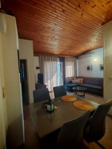 a living room with a table and chairs and a couch at Apartments Marin in Tisno