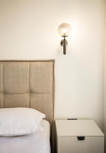 a bedroom with a bed and a nightstand with a lamp at Villa Terra Promessa in Ulcinj