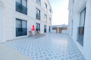 an empty courtyard of a building with two chairs at Black Royal Belek in Belek