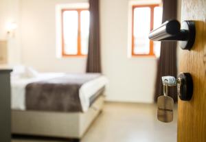a bedroom with a bed and a door with a key at Villa Terra Promessa in Ulcinj