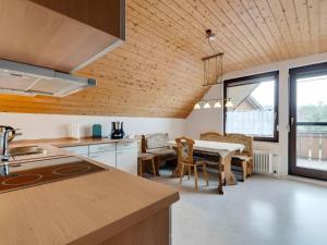 a kitchen and dining room with a table and chairs at Ferienwohnung Sanna in Niedereschach