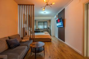 a living room with a couch and a bed at Blvd Ivory Pipera nr 38 in Bucharest