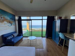 a bedroom with a bed and a view of the ocean at Beachfront Hotel, La Mercy in Umhlanga