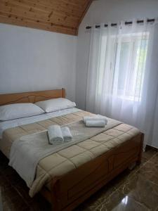a bedroom with a bed with two towels on it at Bujtina Milani in Theth