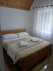 a bedroom with a bed with two towels on it at Bujtina Milani in Theth +21 photos