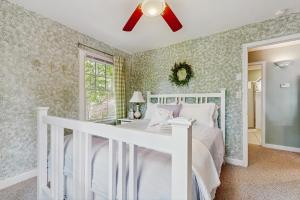 a bedroom with a white bed and a ceiling fan at The Cottage at Sunset in Moneta