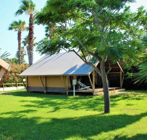 a gazebo with a blue roof in a yard at Village Glamping Biscione in Petrosino