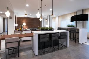 uma cozinha com uma grande ilha com bancos de bar em Wingate by Wyndham Sidney em Sidney