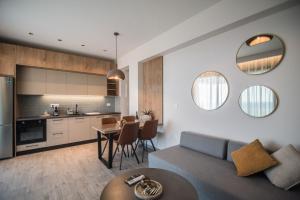 a living room and kitchen with a couch and a table at Gialos Villas Paleochora in Palaiochora