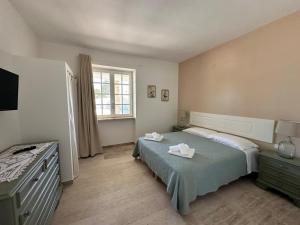 a bedroom with a bed with two towels on it at Otto Trulli Apulian Country House in Noci +60 photos