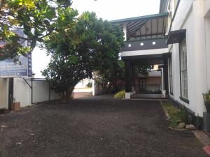 an entrance to a building with a tree at Akira Beach Hotel in Moratuwa