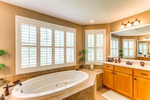 a large bathroom with a large tub and a large mirror at Steps to Bay Tranquil Navarre Retreat with Balcony in Navarre +26 photos