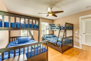 two bunk beds in a room with a ceiling fan at Steps to Bay Tranquil Navarre Retreat with Balcony in Navarre