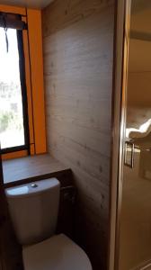 a small bathroom with a toilet and a window at Village Glamping Biscione in Petrosino +40 photos