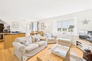 un salon avec un canapé et une télévision dans l'établissement Host & Stay - Dove Cottage, à Warkworth