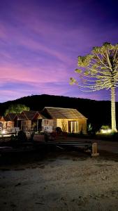 a house with a tree in front of it at Vistas de Mantiqueira in Bom Jardim da Serra