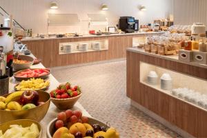 a kitchen with bowls of fruit on a counter at Catalonia Excelsior in Valencia