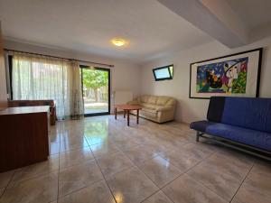 a living room with a couch and a table at Alex House Garden in Iraklitsa