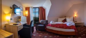 a hotel room with a bed and a desk and a chair at Walpurgishof in Hahnenklee-Bockswiese +21 photos