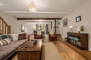 a living room with a couch and a coffee table at Stunning Bowdon Cottage by City SuperHost in Bowdon