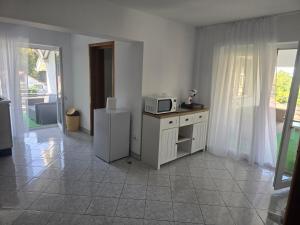 a kitchen with a microwave and a refrigerator at Ramhouse in Piteşti