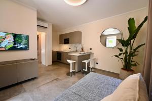 a room with a kitchen and a living room at Casa Luce Como in Como