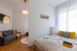 a living room with a couch and a table at TOP Location Studio at Deák Sqr in Budapest